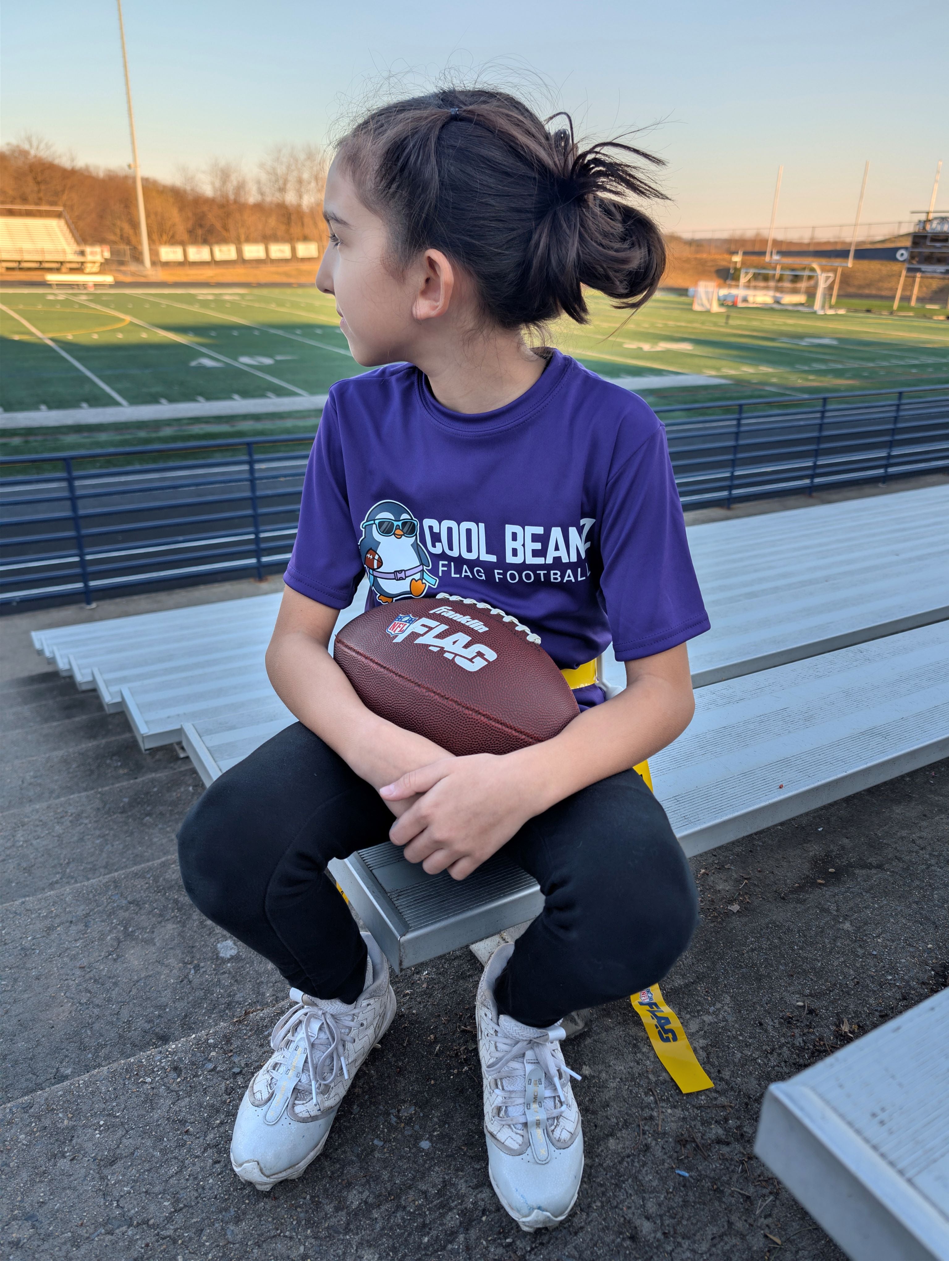 Kids flag football player throwing pass wearing Cool Beanz apparel, youth flag football clothing and team gear